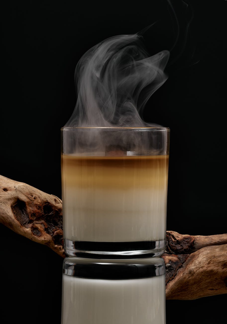 extinguished candle with wooden snag on reflecting table